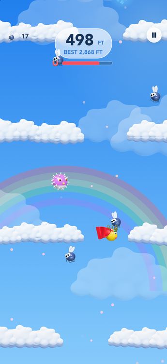 Cloudbank: a rainbow behind white clouds at noon